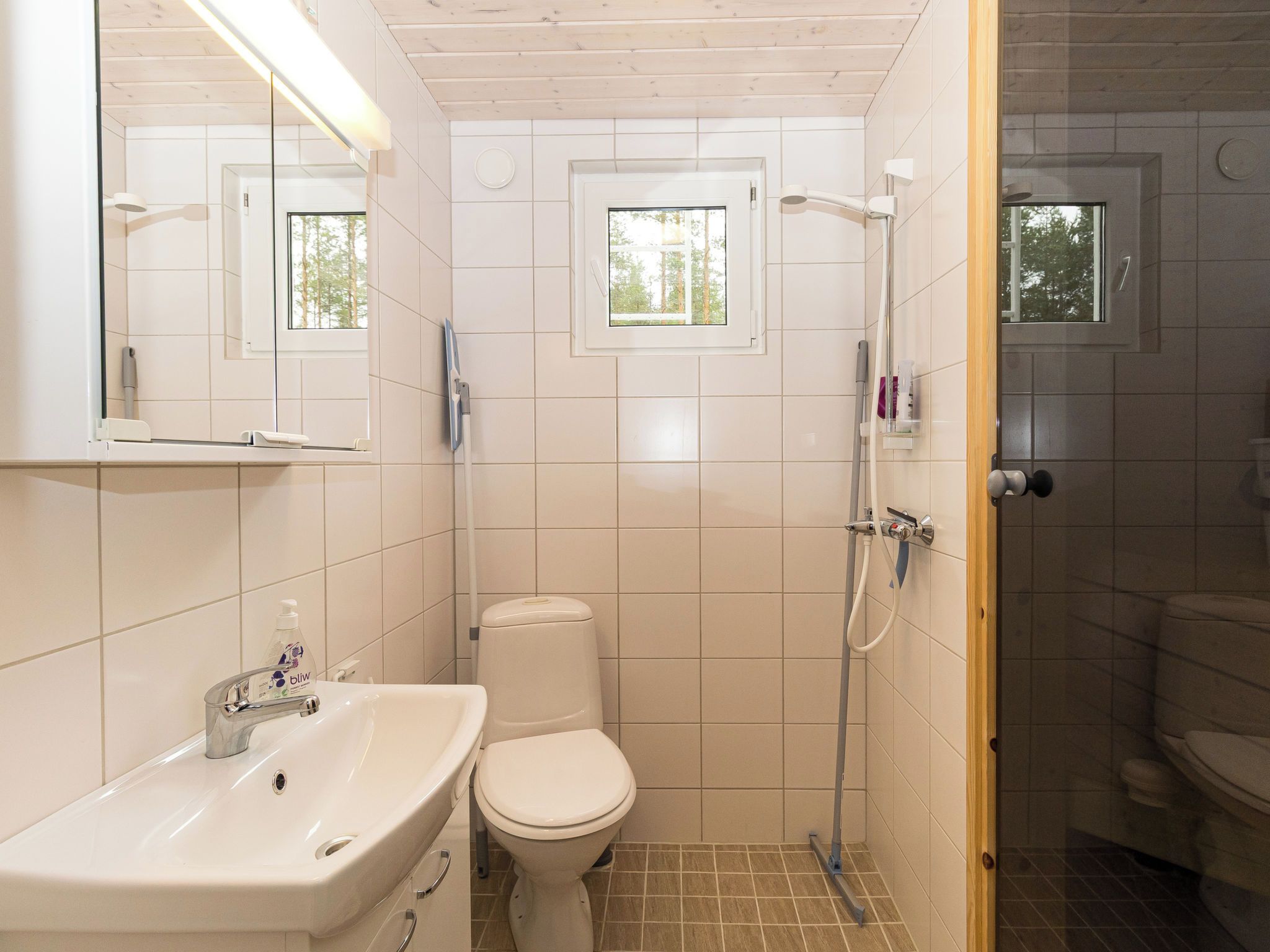 Une salle de bain moderne équipée de toilettes, d’un lavabo et d’une douche.