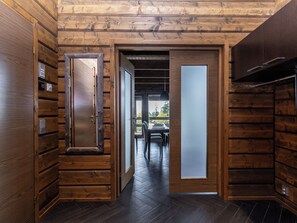 A wooden interior with a hallway leading to a dining area. - Villa midnight sun by Interhome (Inari)