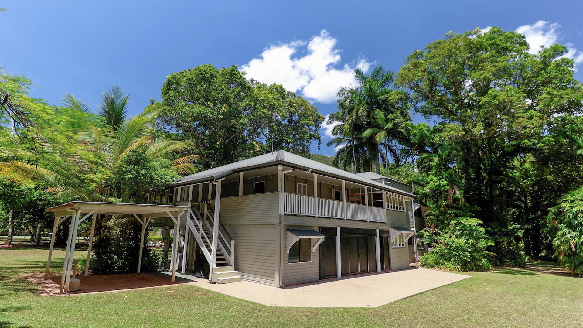 A two-story house with a covered porch and a garage.