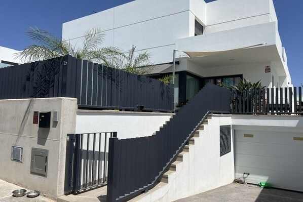 A modern two-story building with a staircase leading to the upper level.