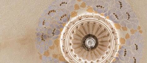 A spiral staircase with a decorative pattern on the wall.