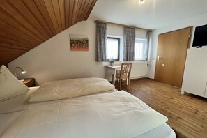 A bedroom with a bed, a desk, a chair, and a wardrobe. - Holiday apartment in Todtnau with barbecue (Todtnau)