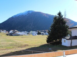 Ein Wohngebiet mit Häusern, einem großen Berg und wolkenlosem Himmel.