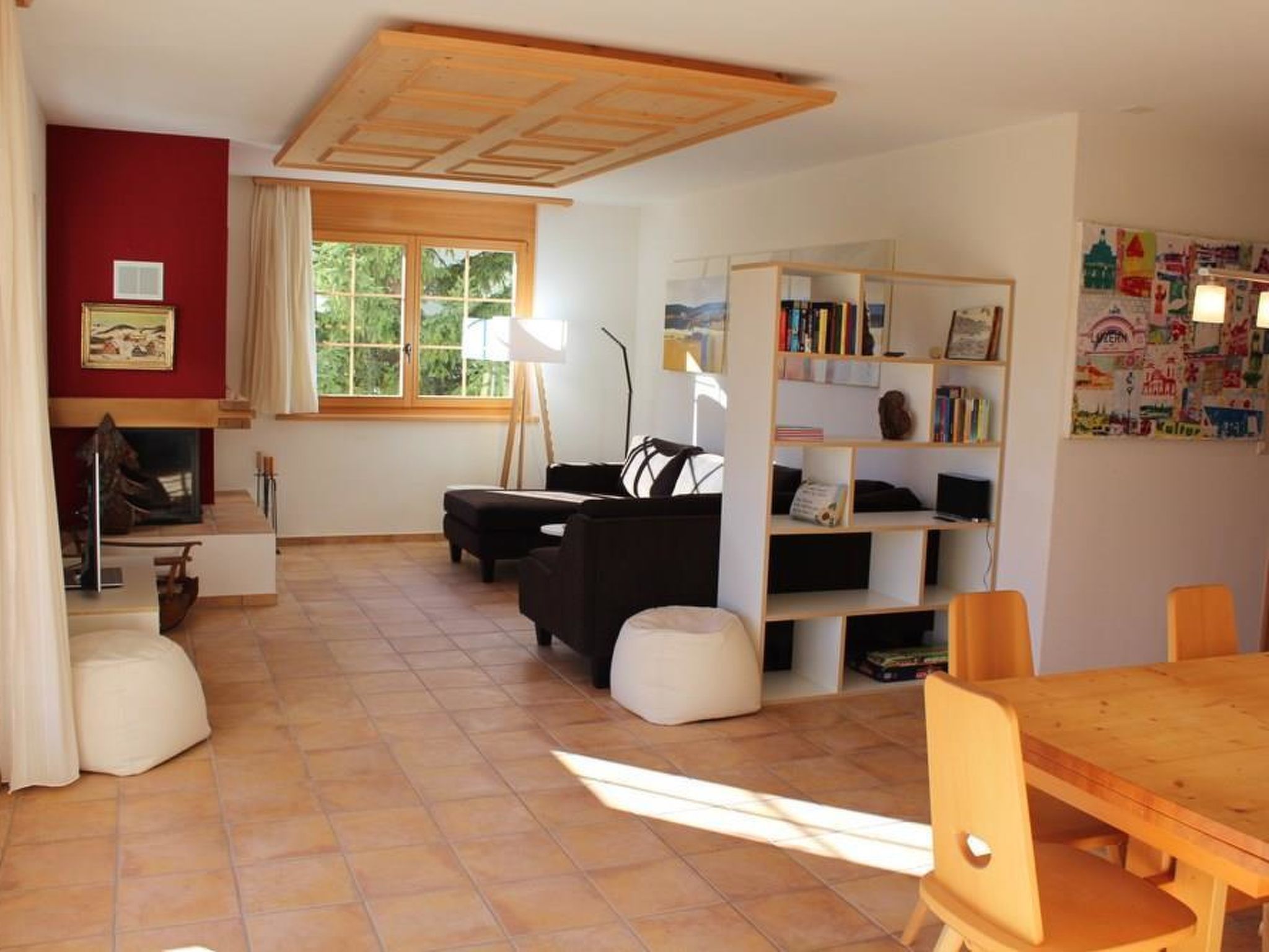 A living room with a fireplace, a sofa, a coffee table, and a bookshelf.