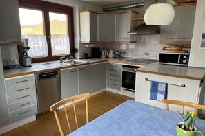 A compact kitchen with a dishwasher, microwave, and stove. - Holiday apartment with 2 bedrooms (Oberried)