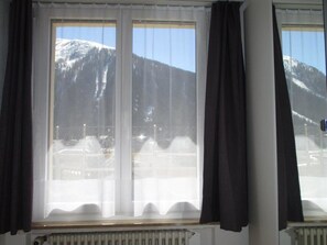 A room with a large window overlooking a snowy mountain landscape. - Bündalodge 1034 Appartement/Fewo, Dusche oder Bad, WC 2-Zimmerwohnung by Interhome (Davos)