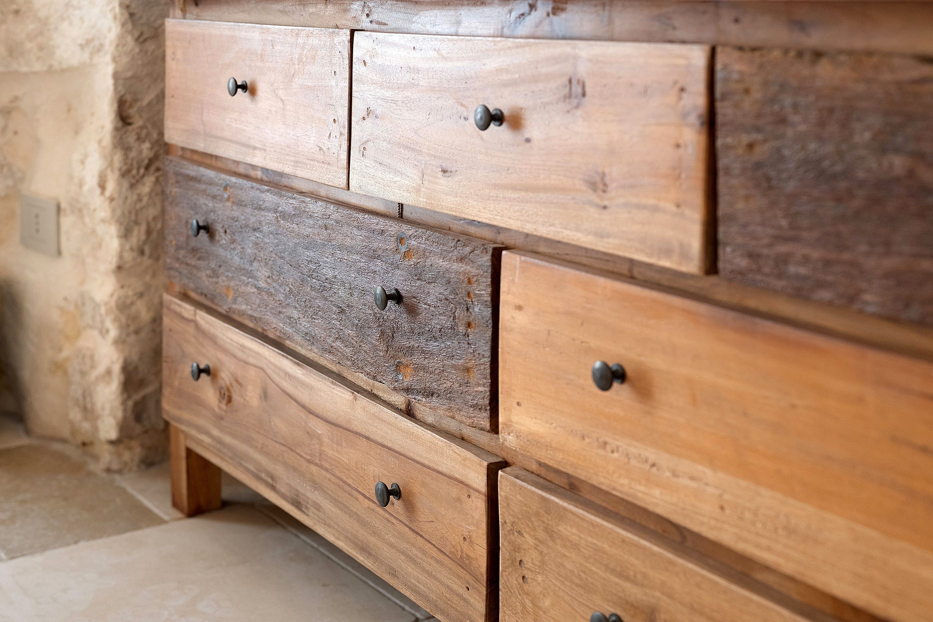 A wooden dresser with multiple drawers and knobs.