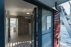 A modern interior with a glass door leading to a deck area.