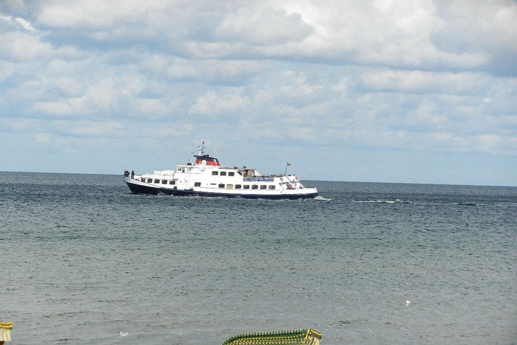 A large white boat on calm water.