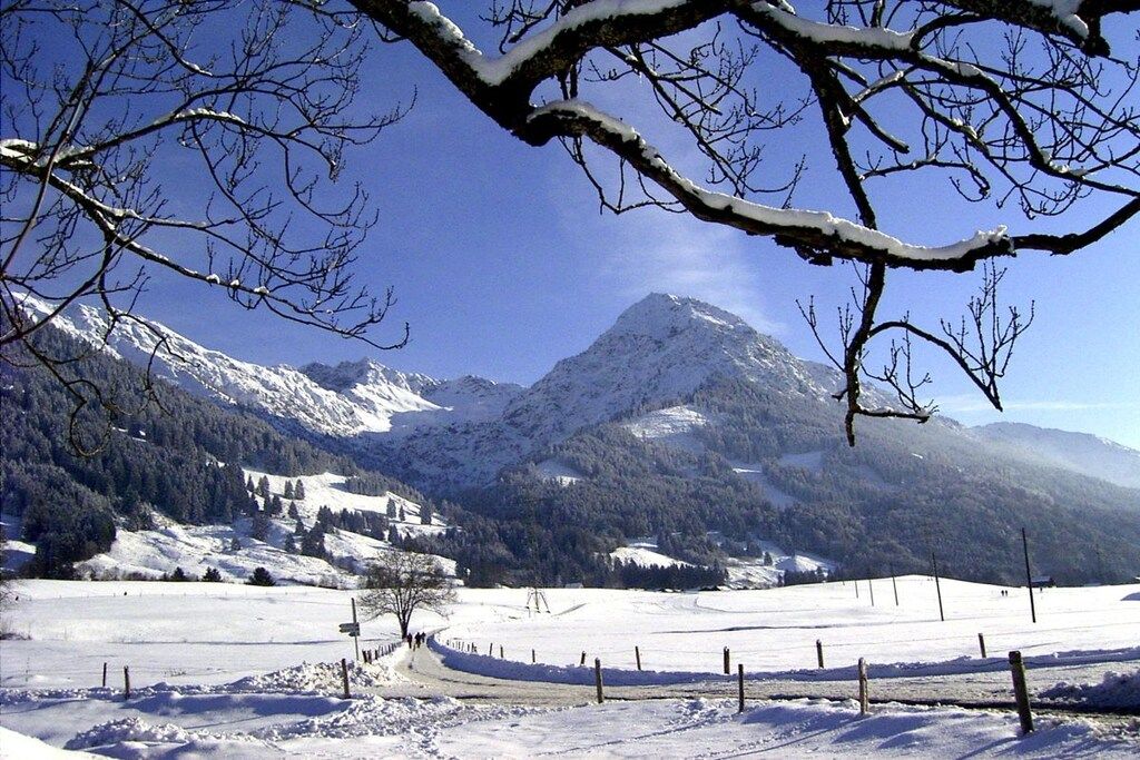 A snow-covered mountain landscape with a clear sky.
