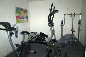 A gym with stationary bikes, a treadmill, and a bench. - Holiday apartment with 1 bedroom (Braunlage)