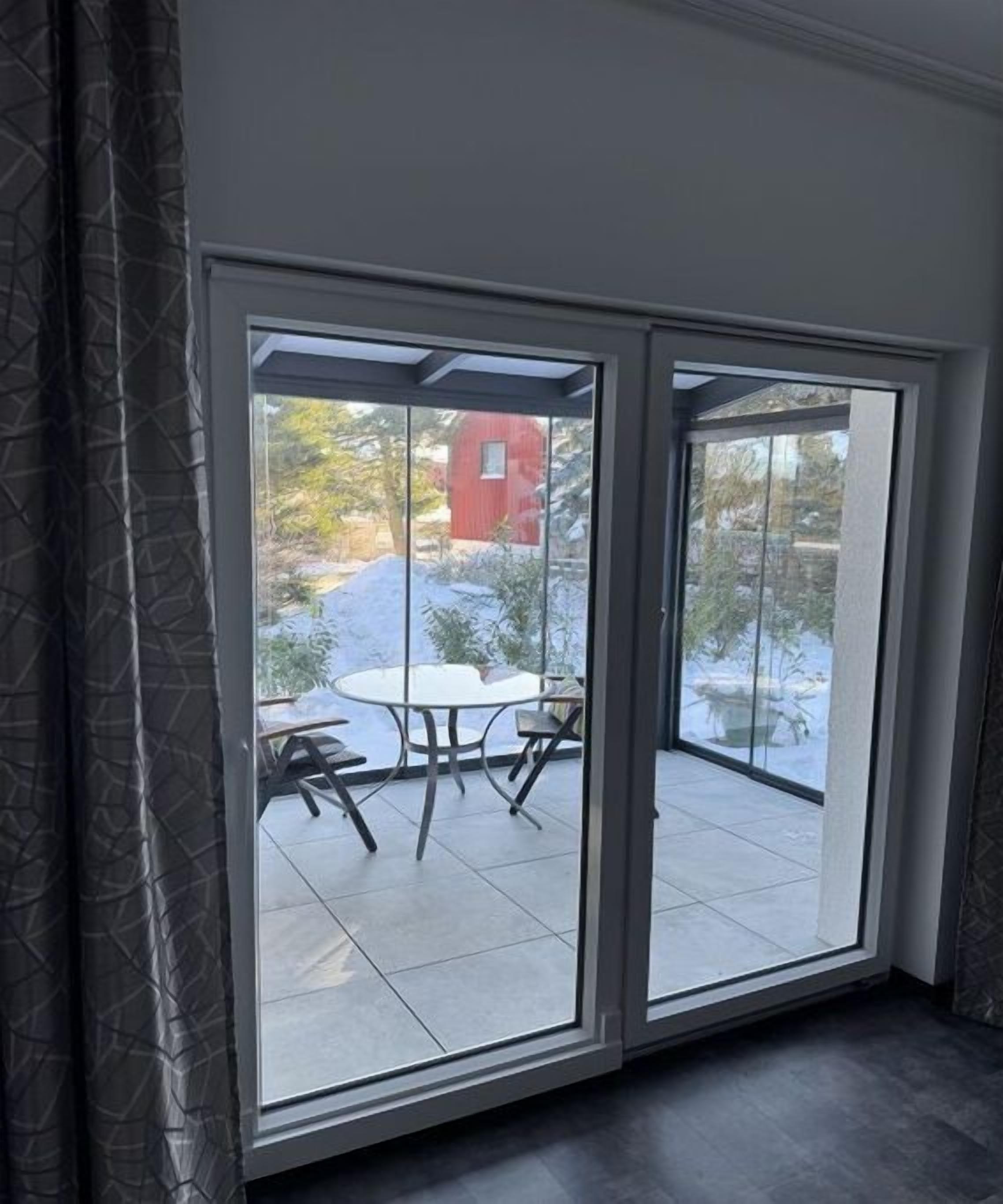 A room with a sliding glass door leading to an outdoor patio area.
