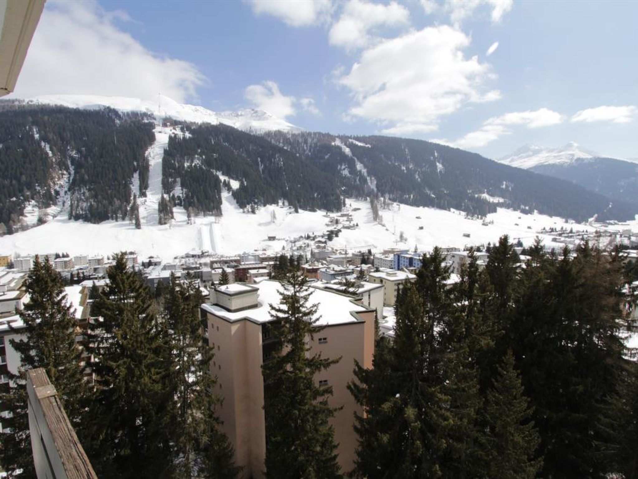 A snow-covered mountain landscape with a town in the foreground.