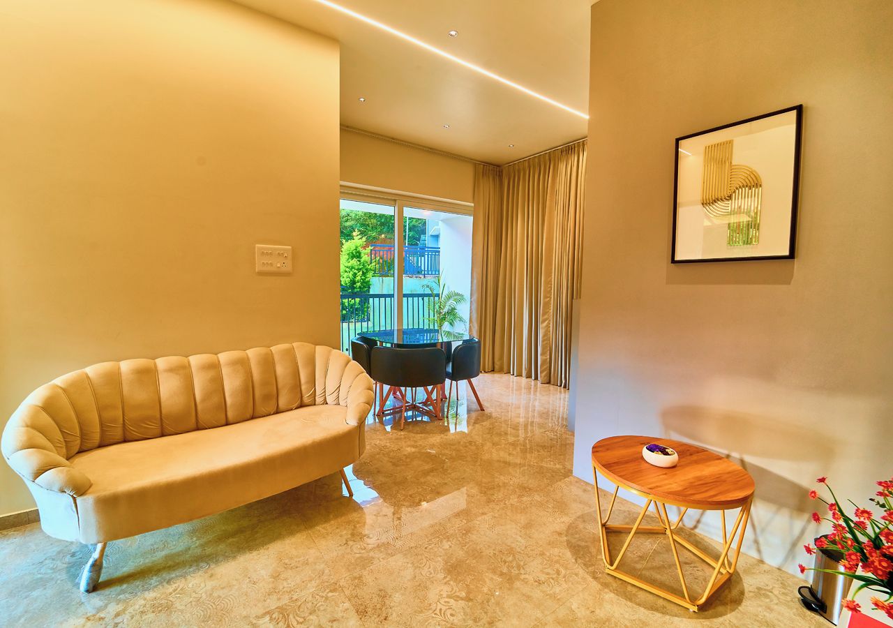 A modern living room with a sofa, a round table, and a coffee table.