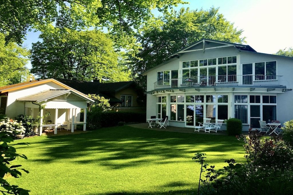 A two-story building with a covered patio and a lawn.