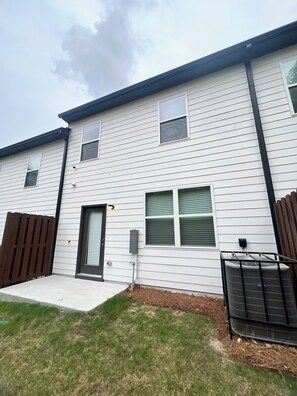 A two-story residential building with a front porch, a mailbox, and a metal fence. - Hidden Atlanta Oasis (Atlanta)