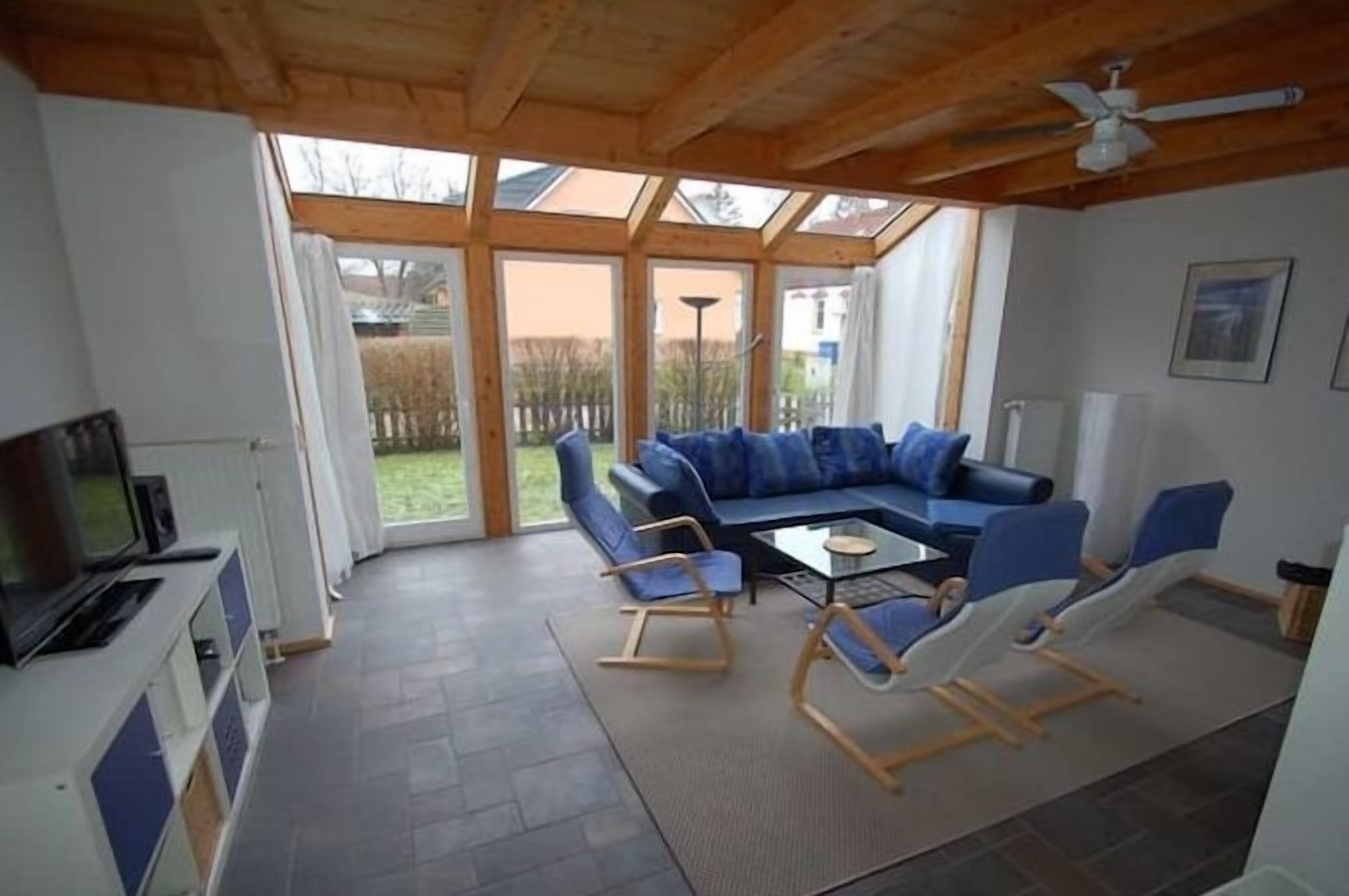 A modern living room with a sectional sofa, a coffee table, and a television.