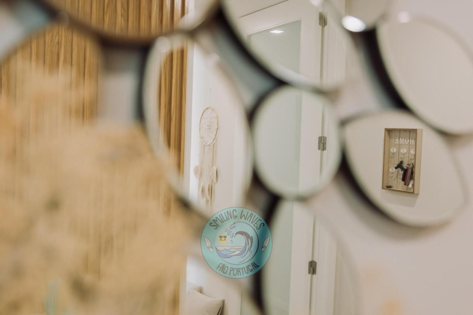 A wall with multiple round mirrors of varying sizes.
