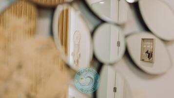 A wall with multiple round mirrors of varying sizes.