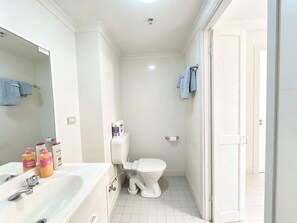 A bathroom with a white sink, toilet, and shower area. - Modern Studio | Central Ultimo Broadway | Shared Kitchen & Laundry (Ultimo)