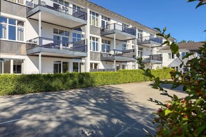 A multi-story residential building with balconies, a paved driveway, and a well-maintained hedge. - Modern Apartment Retreat for 6 in Winterberg Züschen (Winterberg)