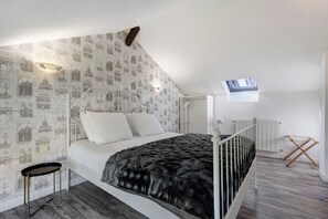 A bedroom with a bed, a nightstand, a window, and a skylight. - Holiday Home “Domaine Logis Gascogne, Gîte 3” Mountain View, Pool & Wi-Fi (Saint-Justin)