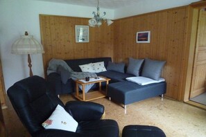 A living room with a sofa, armchairs, a small table, and a lamp. - Holiday apartment with 2 bedrooms (Oberreute.)