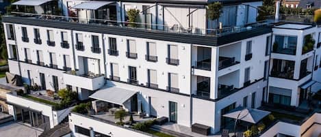 A multi-story hotel with balconies, a flat roof, and a modern architectural style.