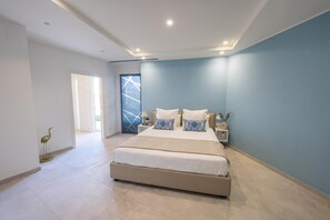 A modern bedroom with a large bed, bedside tables, and a view of the outdoors. - Villa Venere With Garden & Parking (Ceriale)