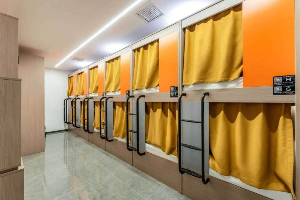 A row of hotel rooms with individual curtains and a uniform color scheme.