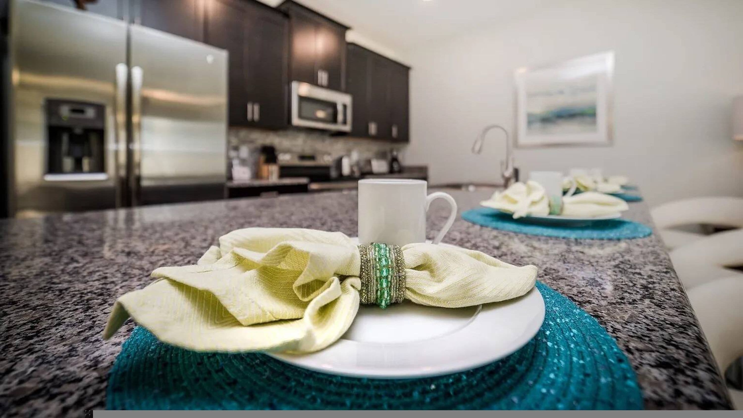 A kitchen with dark cabinets, a microwave, and a coffee machine.