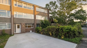 A two-story residential building with a brick facade, multiple windows, and a front yard with greenery. - Spacious 4BDR Home Garden and Parking in Windsor (Slough)