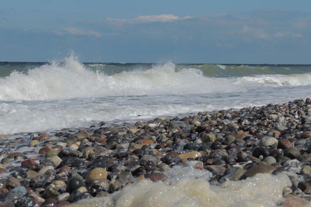 A rocky beach with waves crashing onto the shore.