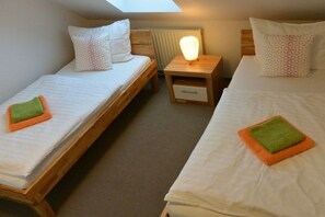 A room with two single beds, each with a pillow and a small bedside table. - Altschulze "Water Lily" (Schwielochsee OT Zaue)
