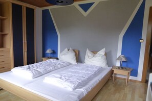 Ein Schlafzimmer mit einem Bett, zwei Nachttischen und einem Kleiderschrank.