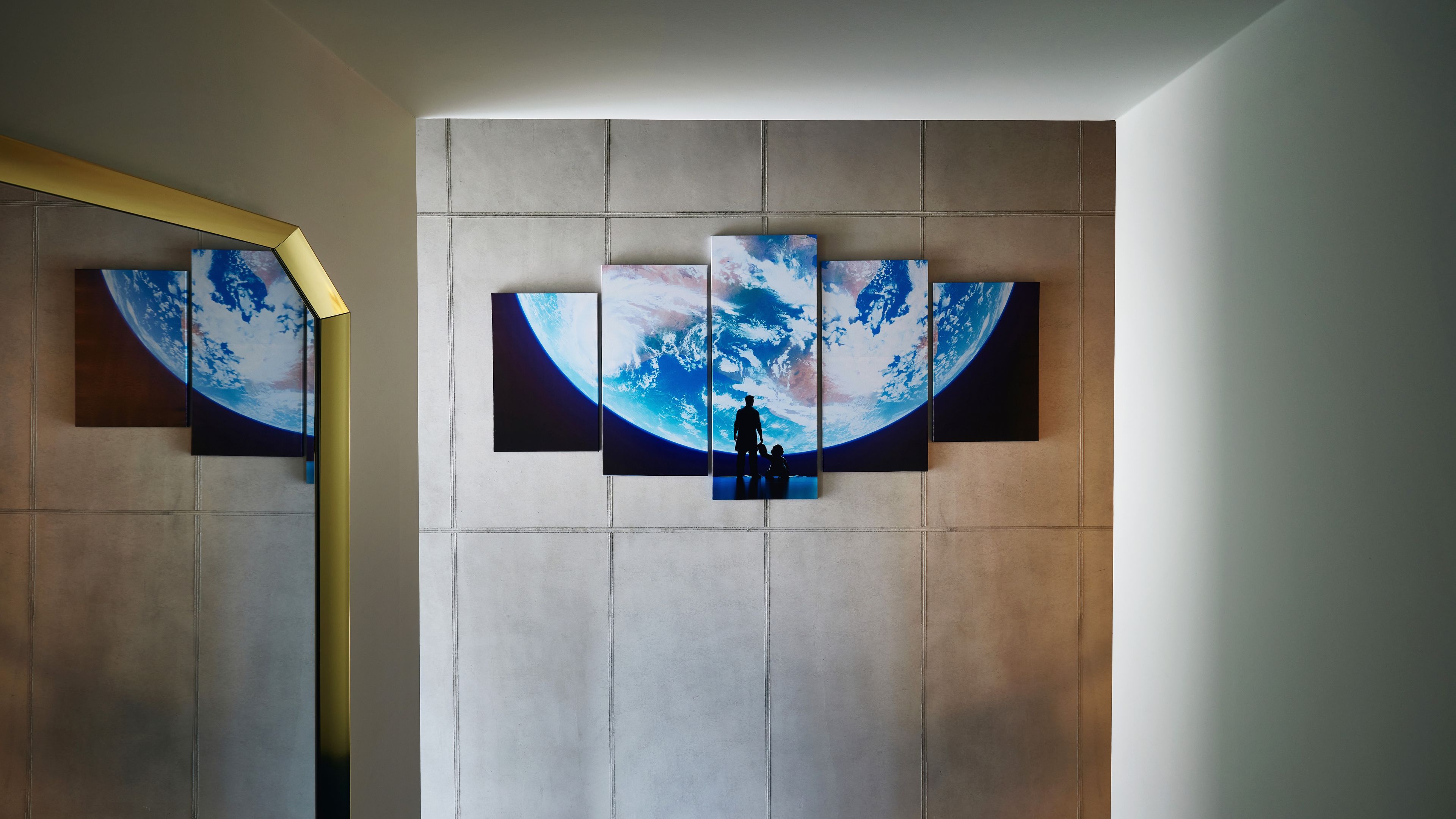A wall with a large abstract painting of a blue and white landscape, possibly depicting a planet or the sky.
