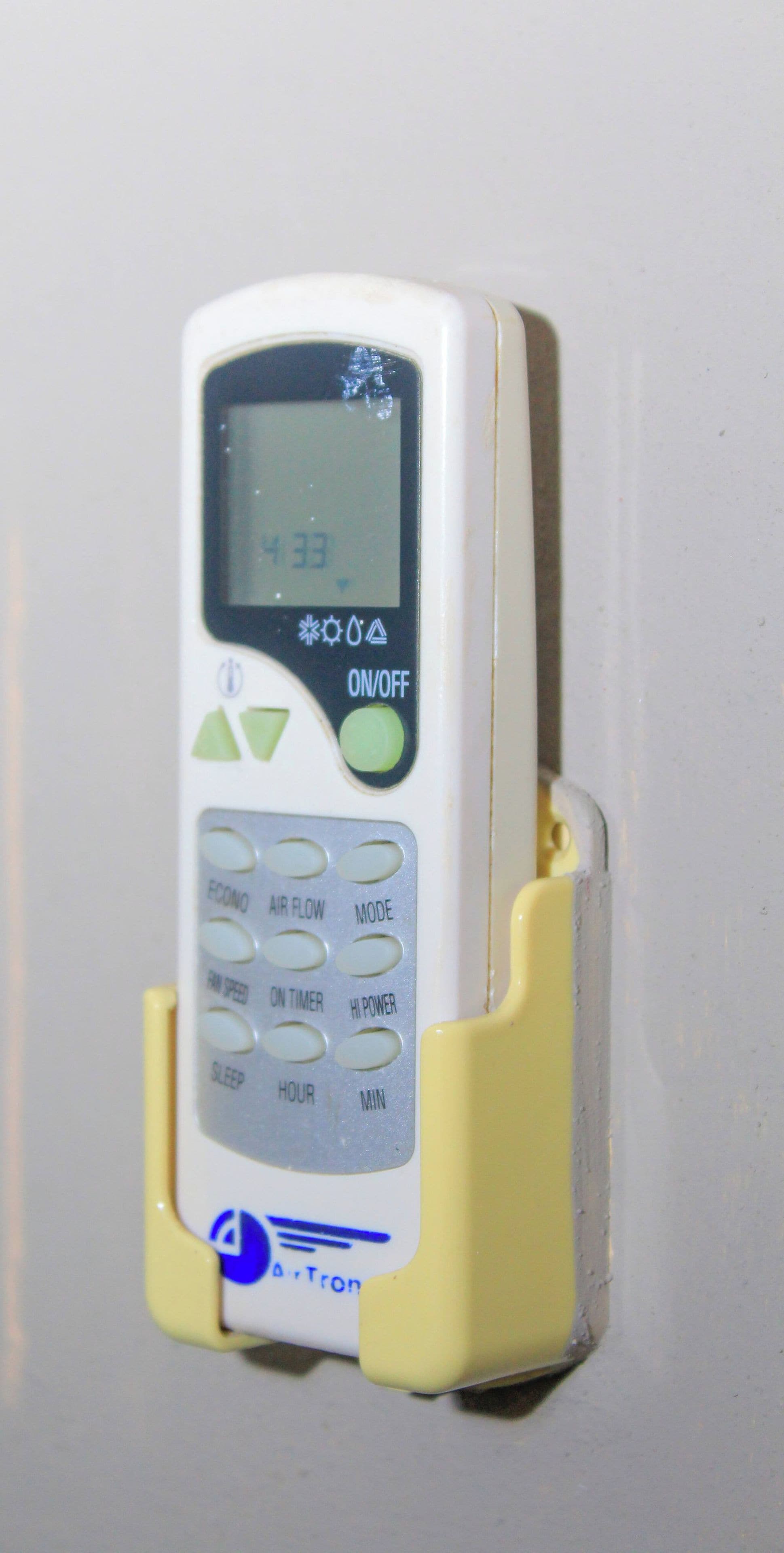 A portable air purifier with a control panel, a power button, and settings for air flow, mode, and timer.