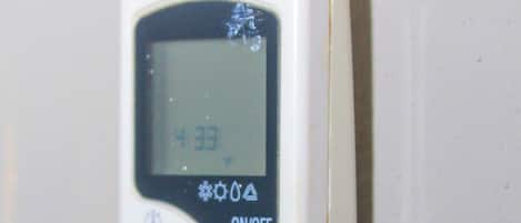 A portable air purifier with a control panel, a power button, and settings for air flow, mode, and timer.