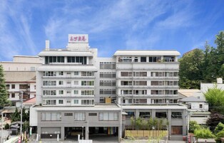 A multi-story building with a flat roof and a sign on top.