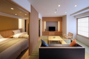 A hotel room with a bed, a sofa, a TV, and a window. - Kami No Yama Azumaya (Kaminoyama)
