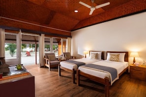 A hotel room with two beds, a ceiling fan, and a view of the outdoors. - Bangaram Island - Ihcl Seleqtions (Bangaram Island)