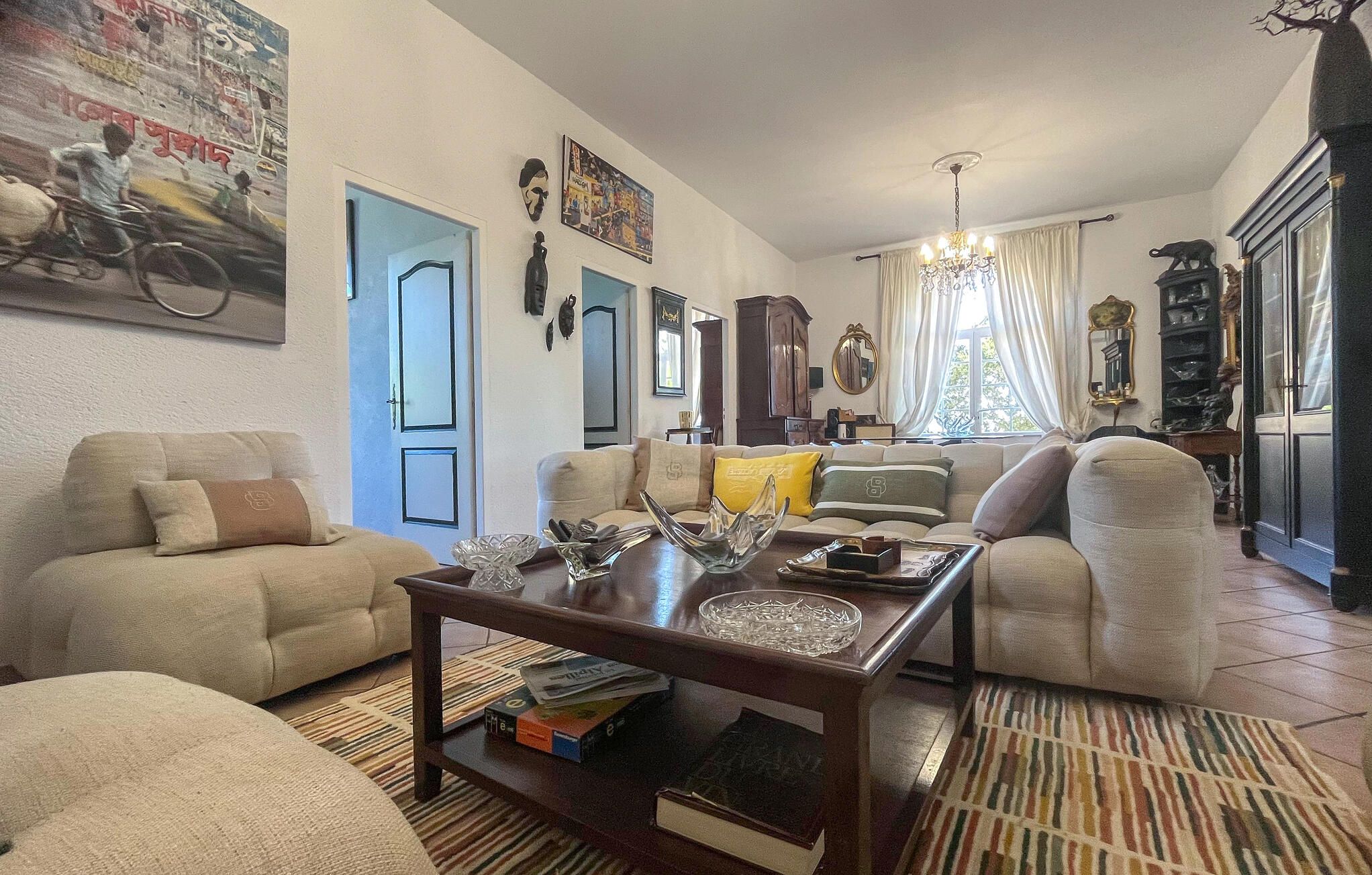 A living room with a sofa, a coffee table, and a bookshelf.