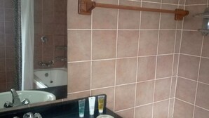 A bathroom with a sink, mirror, and toiletries. - Chaminuka Luxury Lodge (Lusaka)