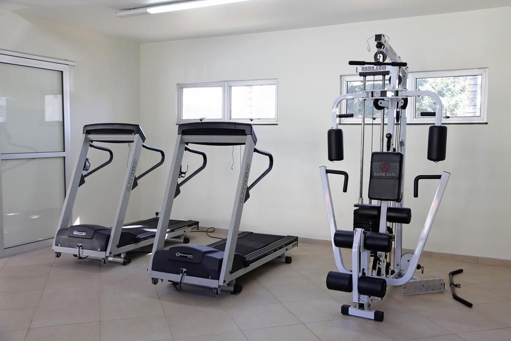 A fitness room with treadmills and a weight machine.