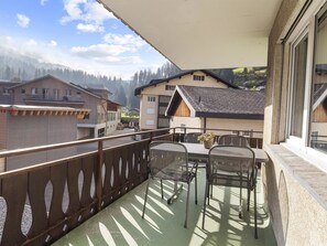 A balcony with two chairs and a table, overlooking a mountainous landscape. - Seeli Appartement/Fewo,   Ferienwohnung Seeli IH by Interhome (Churwalden)