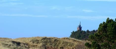 A landscape with a hill and a tower-like structure on top.