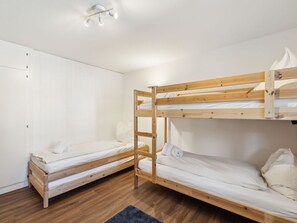 A room with two bunk beds, a wardrobe, and a ceiling light fixture. - Nr.06 Haus Sursilvana Appartement/Fewo,   Nr.06 Haus Sursilvana IH by Interhome (Lenzerheide)