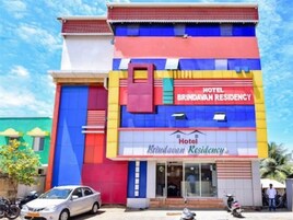 Un edificio de varios pisos con un cartel que dice 'Hotel Brindavan Residency'.
