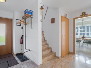Ein modernes Interieur mit einer Treppe, einem Feuerlöscher und einem Essbereich mit Ausblick.