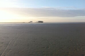 Ein Strand mit einer Struktur in der Ferne.